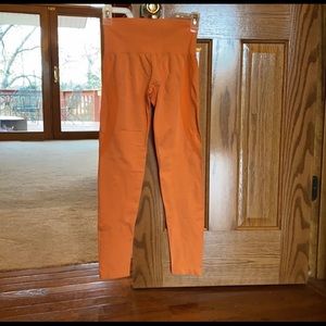 Small NVGTN leggings. Orange color.